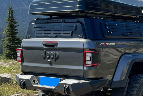 Gray Jeep truck with roof rack canopy on a white background