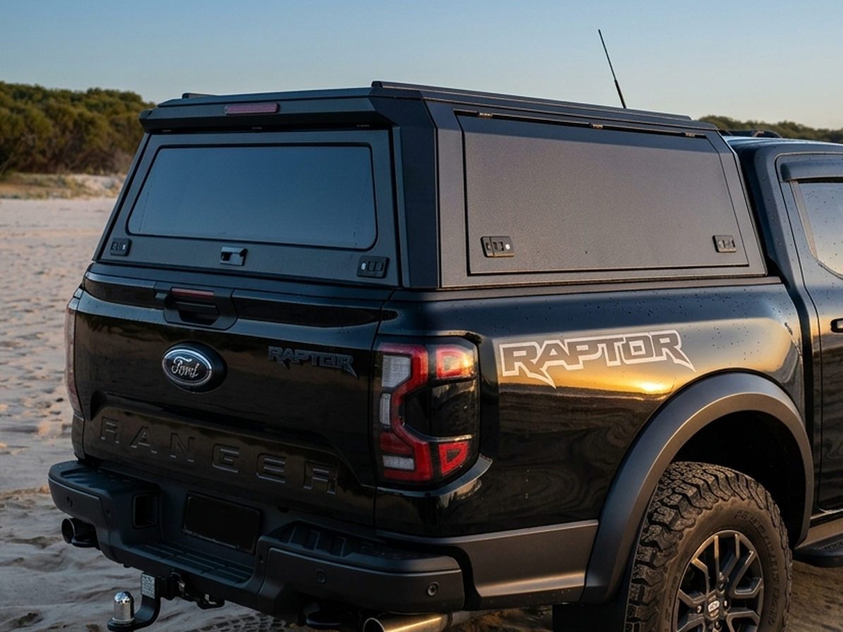 Black Ford Raptor truck on a beach with custom canopies modular ute tub canopy