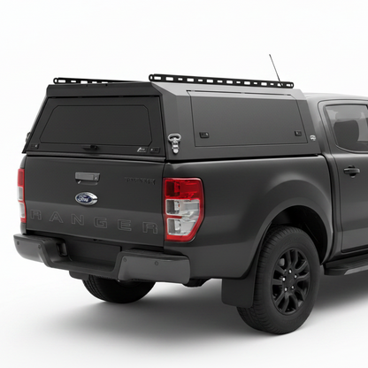 Black Ford Ranger truck with a custom canopy on a white background
