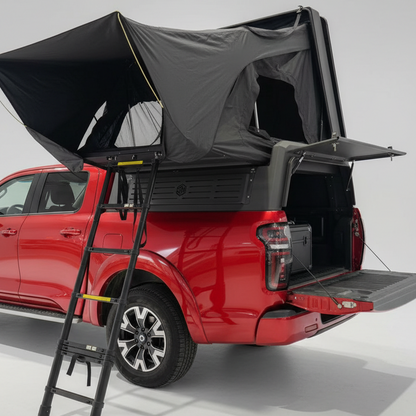 Red truck  with custom canopies stealth camper with a rooftop tent and ladder on a gray background