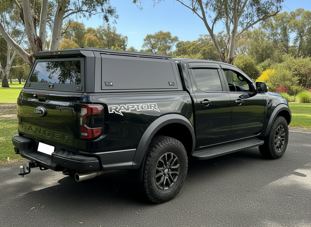 Black Ford Ranger Raptor ute truck with aluminium custom canopy with a forest background